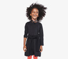 Child wearing Primary Long Sleeve Pocket Dress - Black. Available at www.tenlittle.com