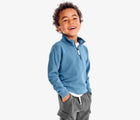 Boy wearing Primary French Terry Quarter Zip Sweatshirt - Moonlight. Available at www.tenlittle.com