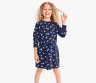 Child wearing Primary Sweatshirt Dress - Rainbow Stars - Navy / Confetti Stars. Available at www.tenlittle.com