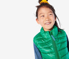 Child wearing Primary - Lightweight Puffer Vest - Green Bean - Available at www.tenlittle.com