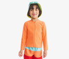 Child wearing Primary Long Sleeve Full-Zip Rash Guard - Cantaloupe. Available at www.tenlittle.com