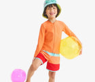 Child wearing Primary Long Sleeve Full-Zip Rash Guard - Cantaloupe. Available at www.tenlittle.com
