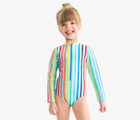 Child wearing Primary Long Sleeve One-Piece Rash Guard - Mist Rainbow Stripe. Available at www.tenlittle.com
