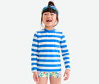 Girl wearing Primary Long Sleeve Patterned Rash Guard - Blueberry / White Stripe. Available at www.tenlittle.com