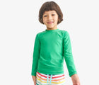 Child wearing Primary Long Sleeve Rash Guard - Green Apple. Available at www.tenlittle.com