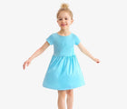 Child twirling wearing Primary Pocket Dress - Lagoon. Available at www.tenlittle.com