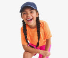 Child wearing Primary StayCool Classic Tee - Cantaloupe. Available at www.tenlittle.com