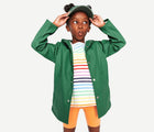 Girl wearing Primary - Sustainable Raincoat - Chive - Available at www.tenlittle.com