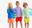 Children wearing Primary Long Sleeve Rash Guard - Blueberry, Iris, Pear. Available at www.tenlittle.com