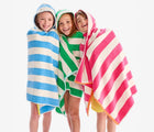 Children wearing Primary Hooded Towels in Bubblegum, Cornflower and Green Apple Stripe. Available from www.tenlittle.com