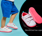 Split view of top and bottom outsole traction and child wearing Ten Little Everyday Original - Neon Glow featuring reinforced toe caps - Neon Pink. Available at www.tenlittle.com