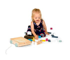 Girl playing with Bigjigs Brick Wooden Cart. Available from www.tenlittle.com.