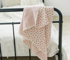 Bloomere Muslin Blanket Cherry on bed - Available at www.tenlittle.com
