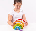 Girl playing with Bigjigs Wooden Stacking Rainbow. Available from www.tenlittle.com.