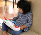 Girl using Blipblox Synthesizer for Kids. Available from www.tenlittle.com.