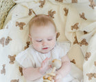 Child Lying and Playing with Bloomere Muslin Blanket Teddy - Available at www.tenlittle.com