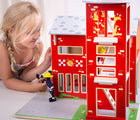 Girl playing with Bigjigs Fire Station. Available from www.tenlittle.com.