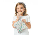 Child holding Bumkins Large Reusable Snack Bag in Cacti. Available at tenlittle.com
