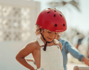 Child wearing Banwood Classic Helmet red - Available at www.tenlittle.com