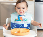 Baby Wearing and Sitting at high chair Bumkins Superbib 3 pack in Dinosaur - Available at www.tenlittle.com
