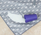 Milk spilled on Bumkins arrow splat mat. Available from www.tenlittle.com