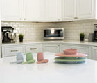 Ezpz First Foods Set in 3 colors.  Coral, Sage and Pewter in the kitchen. Available at www.tenlittle.com