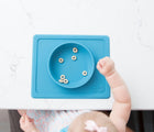 Baby using ezpz Mini Bowl in blue. Available from tenlittle.com