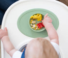 Baby Eating at white tray Ezpz Tiny Bowl Green with food inside.  Available at www.tenlittle.com