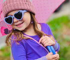 Child wearing Roshambo Heart Sunglasses in lilac. Available from tenlittle.com