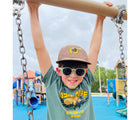 Child wearing Roshambo Round Sunglasses in sage green. Available from tenlittle.com