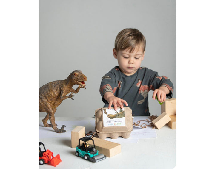 Child playing with Eco-kids Dino Eggs Beeswax Crayons. Available from tenlittle.com