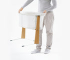 Adult holding BabyBjörn Cradle. Available from tenlittle.com