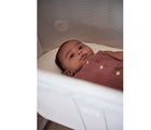 Baby laying inside of BabyBjörn Cradle. Available from tenlittle.com