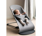 Child in playroom by window sitting in the BabyBjörn 3D Jersey Bouncer Bliss in light gray. Available from tenlittle.com