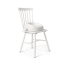 BabyBjörn Booster Seat in white attached to a white chair. Available from tenlittle.com
