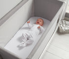 Baby laying in bassinet crib from Béaba Air Complete Sleep System Bassinet-to-Crib. Available from tenlittle.com
