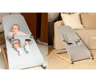 One view of baby in Béaba Evolux Bouncer in jersey, and another view of empty Béaba Evolux Bouncer in jersey next to a couch. Available from tenlittle.com