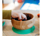 Child's hands taking food out of bowl from the Avanchy Bamboo Suction Bowl & Spoon. Available from tenlittle.com