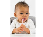 Child with spoon in mouth from Beaba Silicone Spoons - Set of 4. Available from tenlittle.com