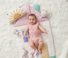 Baby laying on Itzy Ritzy Tummy Time Cottage Play Mat. Available from tenlittle.com