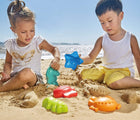 Kids playing with Hape Beach Toy Essential Set on the beach