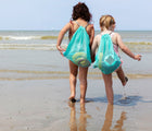 Kids carrying Quut Alto Beach Set on the beach