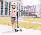 Boy riding Scoot & Ride Highwaykick LED Scooter in white