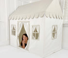 Child playing inside the Domestic Objects Playhouse in grieve. Available from tenlittle.com