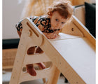 Child standing on ladder of All Circles Collapsable Toddler Slide. Available from tenlittle.com