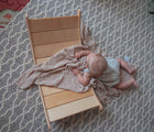 Child laying on floor and All Circles Wobble Board in a living room. Available from tenlittle.com