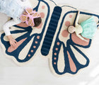 Child and doll laying on Nico & Yeye Butterfly Rug. Available from tenlittle.com