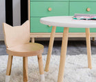 One chair from Nico & Yeye Kitty Chairs - Set of 2 in white in a playroom next to a table and green dresser. Available from tenlittle.com