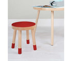 Nico & Yeye Wooden Kids Stools - Set of 2 in red next to a table in a playroom. Available from tenlittle.com