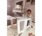 Child using the Little Big Playroom Sit & Stand Kitchen Tower as a table and chair while eating. Available from tenlittle.com